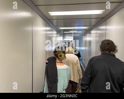 Sanford, FL USA - May 13, 2021:   People waiting in the jetway to board an Allegiant airplane at the Sanford International Airport in Sanford, Florida Stock Photo