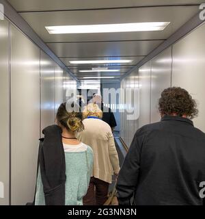 Sanford, FL USA - May 13, 2021:   People waiting in the jetway to board an Allegiant airplane at the Sanford International Airport in Sanford, Florida Stock Photo