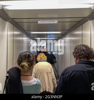 Sanford, FL USA - May 13, 2021:   People waiting in the jetway to board an Allegiant airplane at the Sanford International Airport in Sanford, Florida Stock Photo