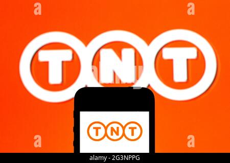 Spain. 16th June, 2021. In this photo illustration a TNT Express logo seen displayed on a smartphone with a TNT Express logo in the background. Credit: Thiago Prudencio/SOPA Images/ZUMA Wire/Alamy Live News Stock Photo