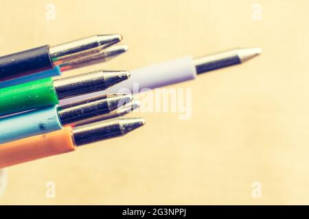 Multi colored pen on a textured background Stock Photo
