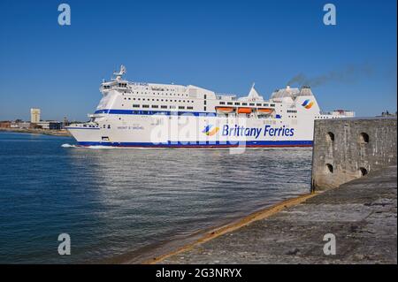 A view from Old Portsmouth of Brittany Ferries' cross-Channel ferry Mont St. Michel departing Portsmouth Harbour at the start of another crossing to C Stock Photo