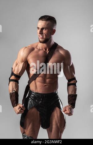 Half length portrait of young handsome muscular man gladiator Stock Photo