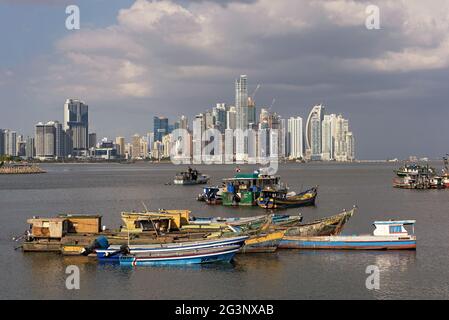 Old wooden fishing boats in front of the skyline of panama city panama Stock Photo