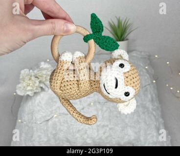 Handmade Crochet Animal Toy - Amigurumi Stuffed Toy - Crochet Monkey Wooden Teether for Babies Stock Photo