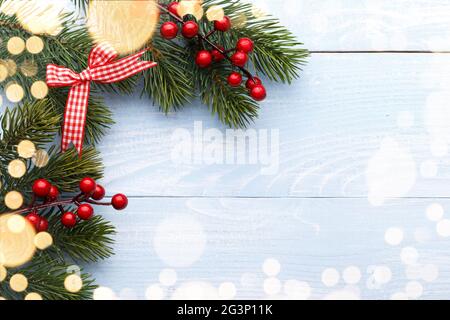 Pine tree branches with red holly berries Stock Photo