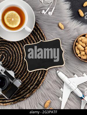 Blank wooden sign with old instant camera plane and tea Stock Photo