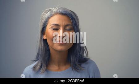 Nice-looking Middle-Aged Woman Is Dreaming Stock Photo