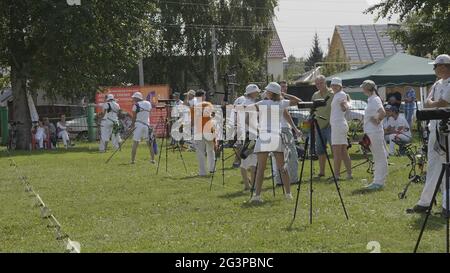 BARNAUL - AUGUST 6: Attractive male archer bending a bow and aiming in the target on August 6, 2017 in Barnaul, Russia. Stock Photo