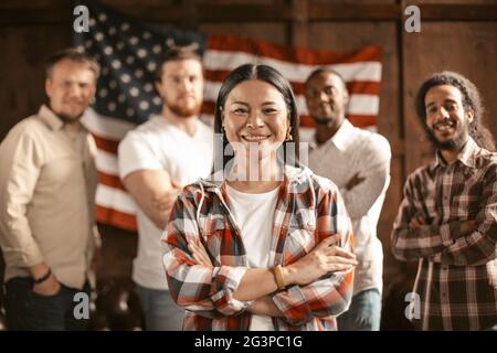 Diverse Group Of American Patriots Standing Against Background Of American Flag Stock Photo