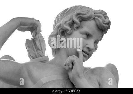 White angel against white isolated background as a symbol love. Ancient Eros statue. Sculpture of young man with quiver and arro Stock Photo
