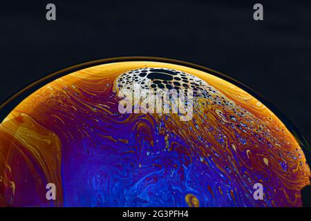 Beautiful psychedelic abstractions on the surface soap bubbles. Stock Photo