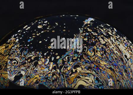 Beautiful psychedelic abstractions on the surface soap bubbles. Stock Photo