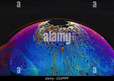 Beautiful psychedelic abstractions on the surface soap bubbles. Stock Photo