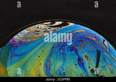 Beautiful psychedelic abstractions on the surface soap bubbles. Stock Photo