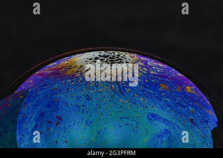 Beautiful psychedelic abstractions on the surface soap bubbles. Stock Photo