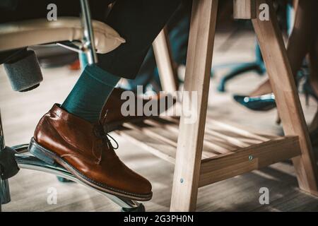 Male Legs In Elegant Brown Leather Shoes Stock Photo