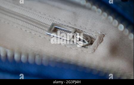 Natural or artificial leather texture. Fragment of a blue bag with a zipper and stitching. Zipper or clasp bag design element. Bovine skin texture wit Stock Photo