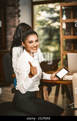 Smiling Business woman Shows Thumb Up Stock Photo