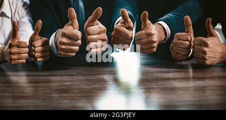 Group Of Business People Shows Thumbs Up Gestures, Close Up Stock Photo