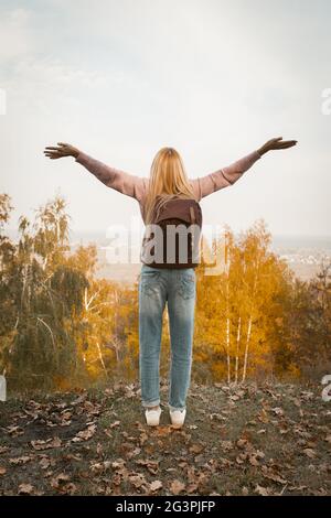 Happy Woman Stands On Mountain Outstretched Her Arms Stock Photo