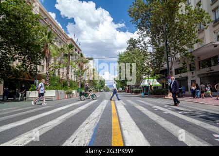 Athenians walking on crosswalk on Panepistimiou avenue, one of the busiest (usually) main streets in Athens, Greece, Europe. Stock Photo