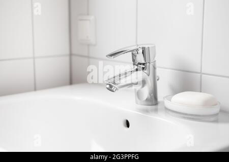 White ceramic sink with faucet and soap Stock Photo