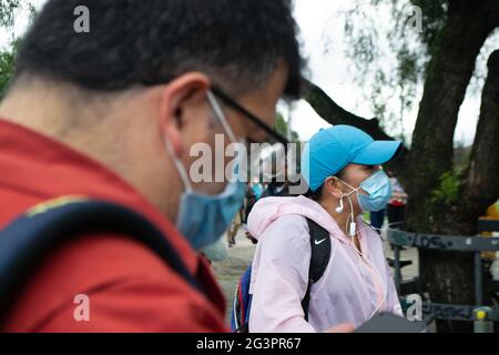 Bogota, Colombia. 17th June, 2021. A man and a woman wait in the middle of the line for the vaccination of the second dose of Pfizer at 'Movistar Arena' in Bogota, Colombia, on June 17, 2021. Soon after Colombia started vaccination to citizens over the age of 45. Credit: Long Visual Press/Alamy Live News Stock Photo