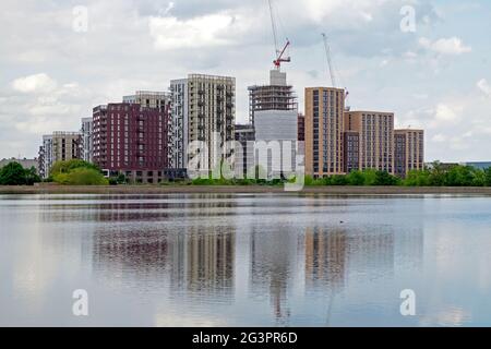 View of new housing residential apartments apartment blocks under construction on edge of a Walthamstow Wetlands reservoir in London N17 England UK Stock Photo