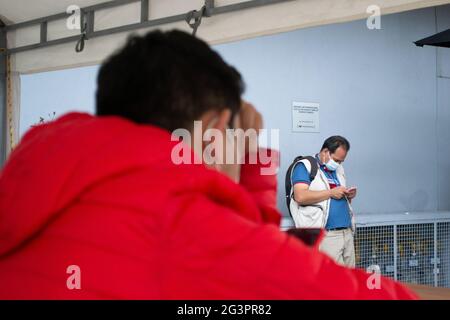 Bogota, Colombia. 17th June, 2021. A man checks his cell phone in the middle of the vaccination against Covid 19, in 'Movistar Arena' in Bogota, Colombia on June 17, 2021. Soon after Colombia started vaccination to citizens over the age of 45. Credit: Long Visual Press/Alamy Live News Stock Photo