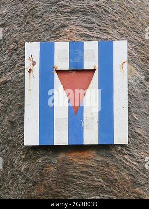 Concentration camp inmates are symbolized by a striped plate with a central triangle Stock Photo