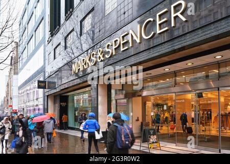London, United Kingdom - February 01, 2019: People walking  front of Marks & Spencer department store on Oxford street, during rainy day. M&S is major Stock Photo
