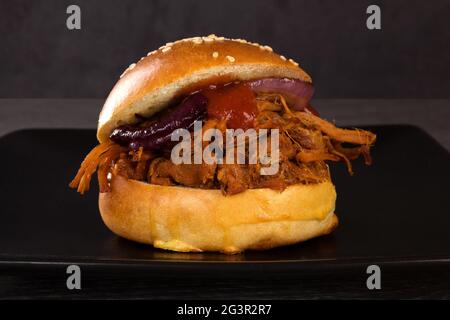 Bbq pulled pork burger on black. Stock Photo
