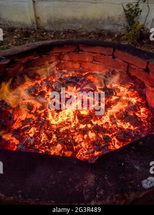 Glowing Fire embers in hot red color, abstract background. The hot embers of burning wood log fire Stock Photo