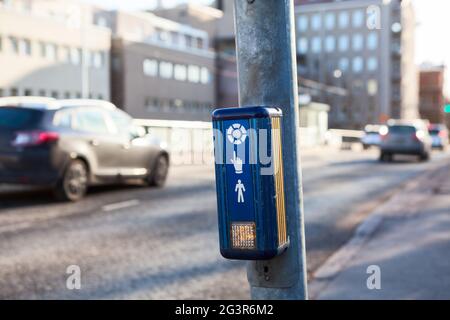 Push button to cross the street with fast driving cars Stock Photo