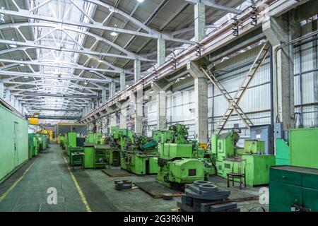 Many machine tools for metalworking in large workshop of plant. Heavy industry. Industrial interior. Stock Photo