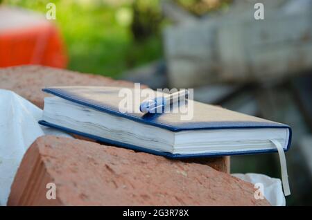The text Study on a wooden cubes, lying on a Notepad with a metal blue pen. Stock Photo