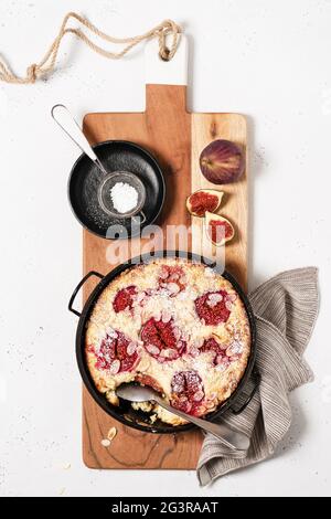 Traditional french pie clafoutis with figs for sweet dessert on a cutting board. Stock Photo