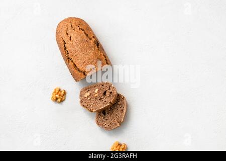 Top view of homemade einkorn bread with walnuts in slices, copy space Stock Photo