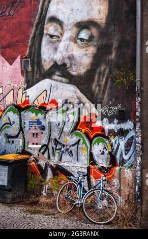 The bike, parked in front of the graffiti wall. . . Stock Photo
