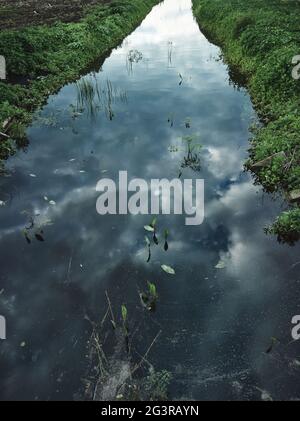 high angle view to a flowing water between too lakesides Stock Photo