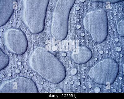 Raindrops on a blue tablecloth horizontal Stock Photo