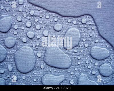 Raindrops on a blue tablecloth near Stock Photo