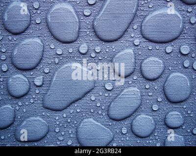 Raindrops on a blue tablecloth Stock Photo