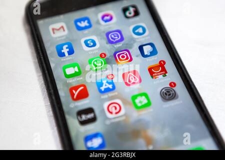 Saint-Petersburg, Russia-circa Mar, 2021: Apple iPhone cellphone with icons of social media as Facebook, Instagram, Viber, WhatsApp applications on sc Stock Photo