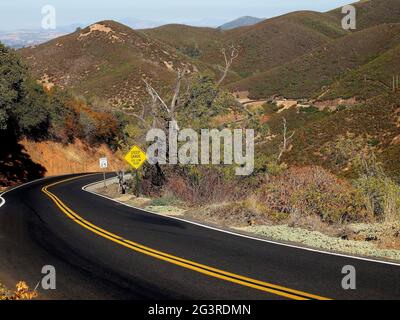 Old Priest Grade, 25 MPH speed limit and steep grade use low gear signs in Tuolumne County, California Stock Photo