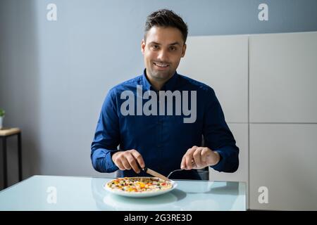 Eating Virtual Lunch. Business Man Tasting Food Stock Photo