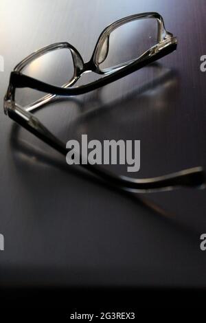 Stylish glasses lie on a gray laptop. Close-up Stock Photo