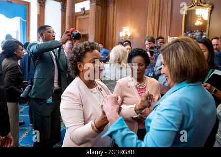 Speaker of the United States House of Representatives Nancy Pelosi (Democrat of California), right, United States Representative Barbara Lee (Democrat of California), left, and United States Representative Sheila Jackson-Lee (Democrat of Texas), center, celebrate the signing of bill S. 475, the Juneteenth National Independence Day Act at the US Capitol in Washington, DC, Thursday, June 17, 2021. Credit: Rod Lamkey/CNP /MediaPunch Stock Photo