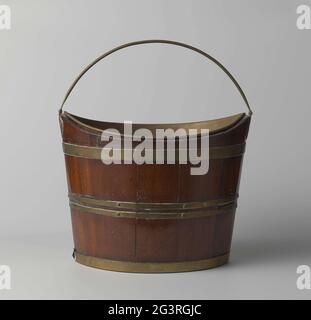 Theestof of wood and brass. The oval teahouse consisting of two parts: the bucket and an inner bin. The bucket is made of wood, decorated with brass tires that are riveted on the lower and top and two brass tires over the center of the bucket, which are also riveted, but with larger nails. The round handle is connected to the bucket by two handle tips. The bottom has two iron pictures in the corners to reinforce. Inside the bucket, a loose brass container is placed, which is made from three plates, the corners of which are folded and roasted. Stock Photo